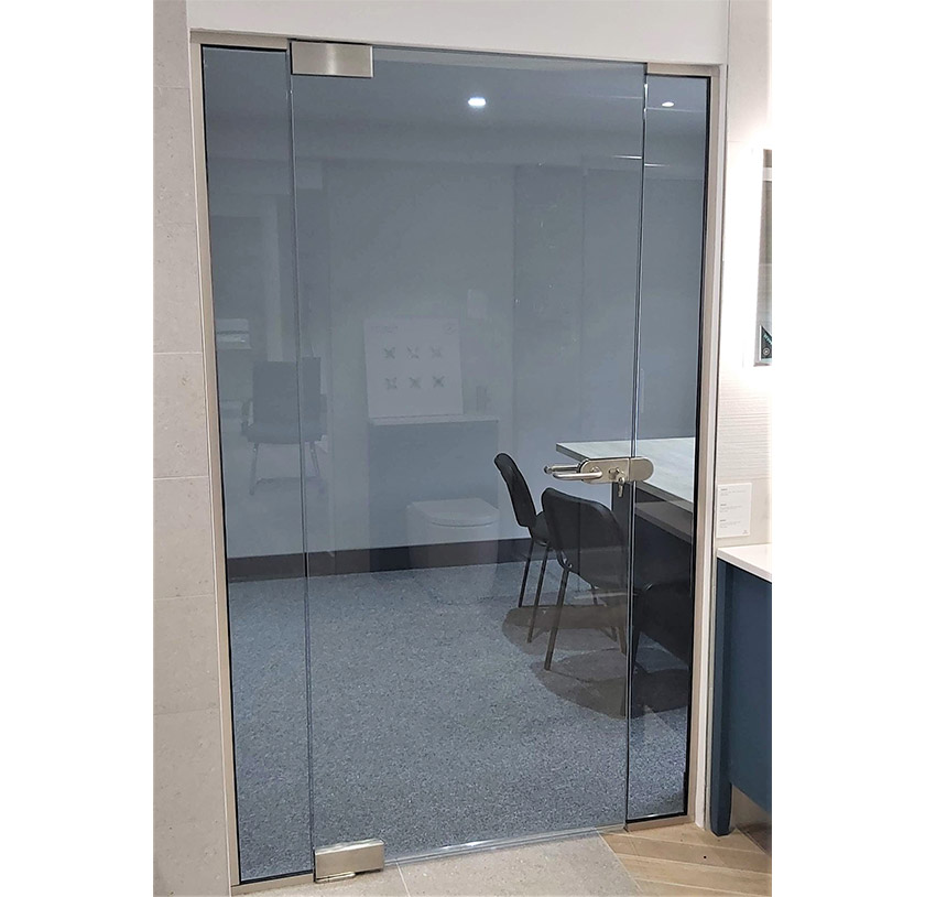 Floor to ceiling glass door in an office