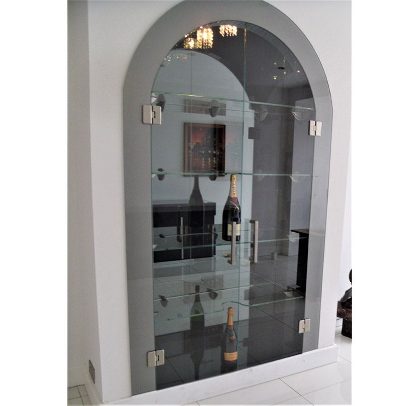Glass shelving in a glass cabinet built into an alcove