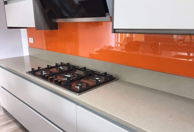 orange glass splashback above kitchen countertop