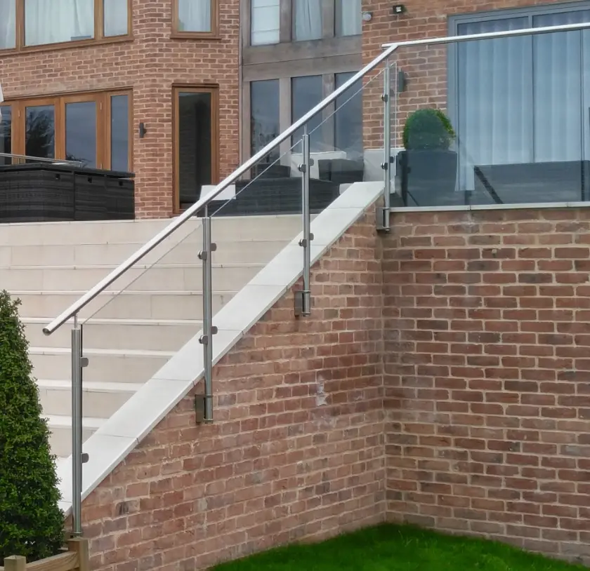 Glass balustrade with stainless steel posts attached to steps outer wall