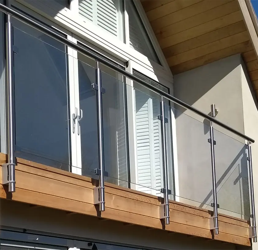Glass balustrade with stainless steel posts fronting an upper floor balcony