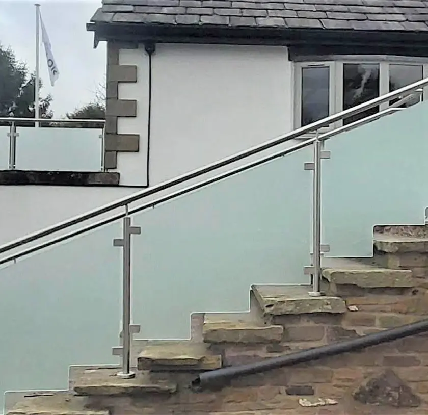 Frosted glass balustrade with stainless steel posts on outdoor stone steps