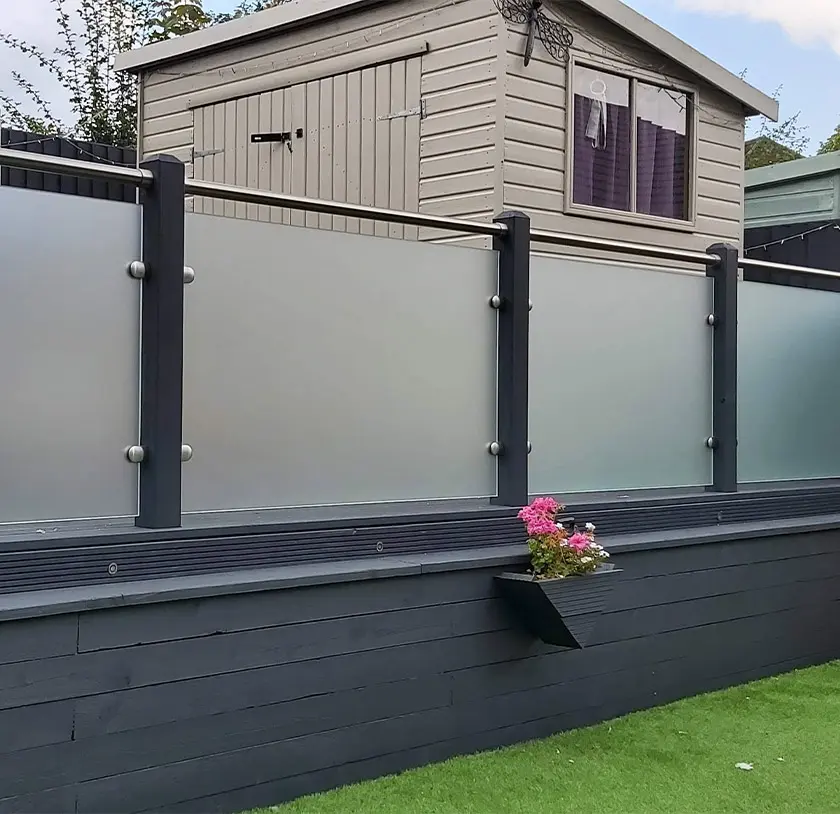 Frosted glass balustrade with stainless steel posts surrounding a shed