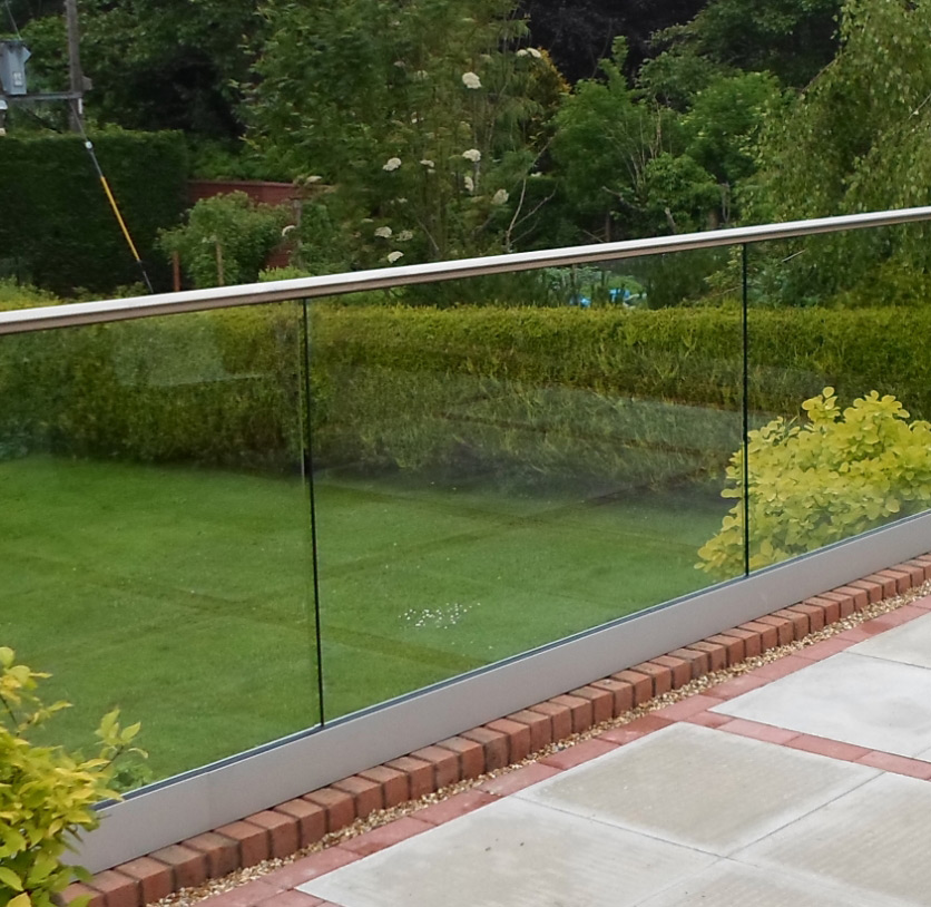 Glass balustrades with stainless steel handrail surrounding a patio