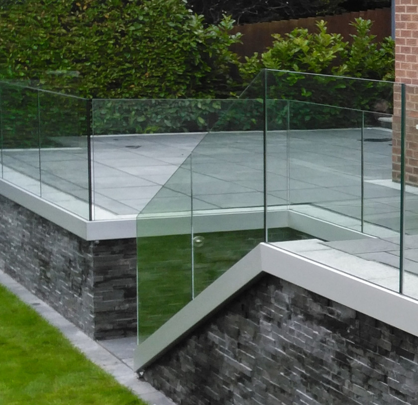 Frameless glass balustrade attached to steps outer wall