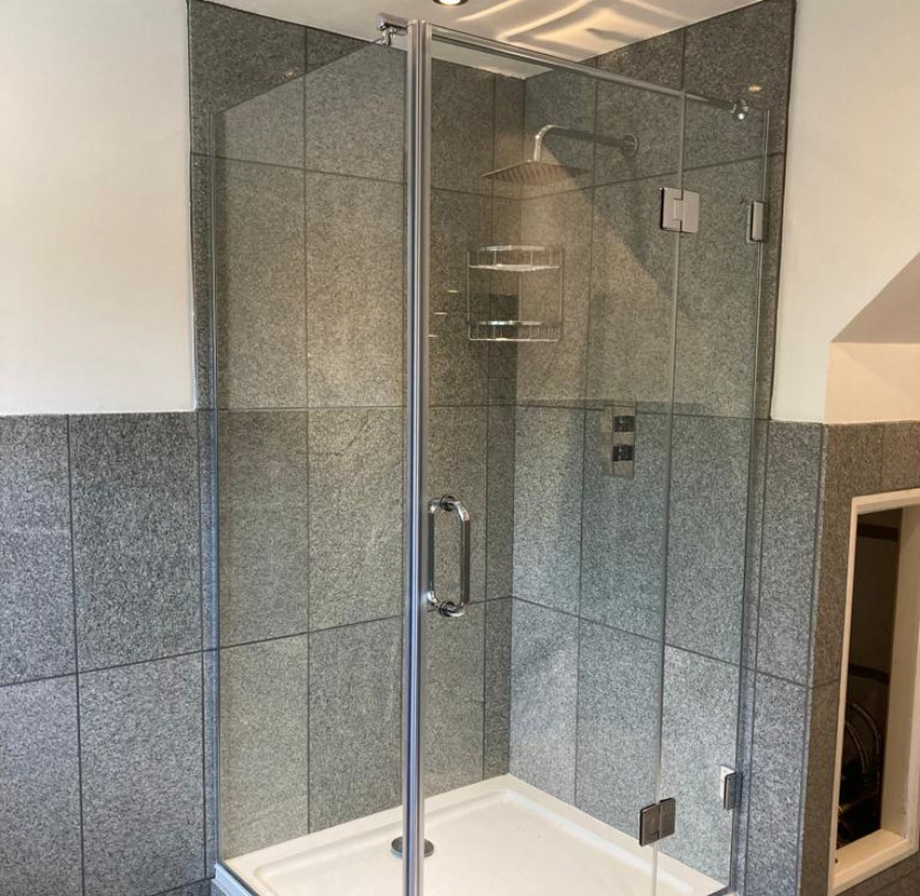 Glass shower screen with stainless steel borders and pull handle