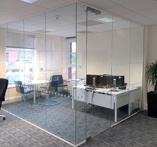 Floor to ceiling glass partition in an office