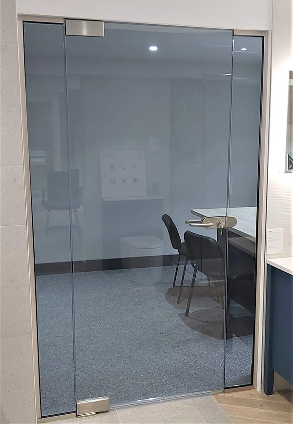 Floor to ceiling glass door in an office
