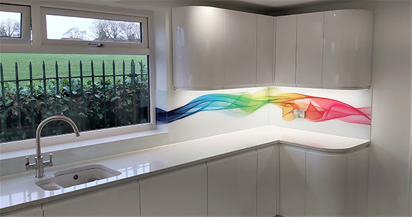 Coloured rainbow ribbon glass splashback above kitchen countertop