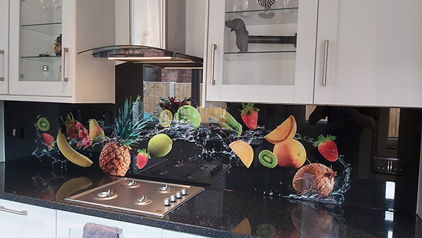 Printed fruit glass splashback above kitchen countertop